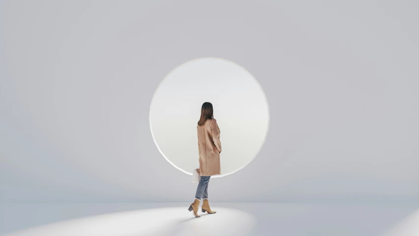 a girl standing in front of a white object