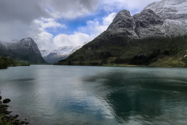 mountain peaks rise over the lake in this scenic scene