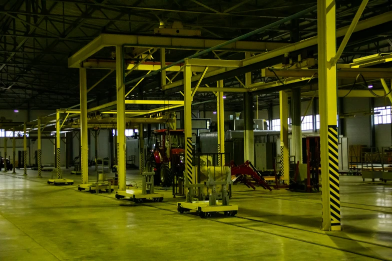 the warehouse is filled with yellow pallets of machinery