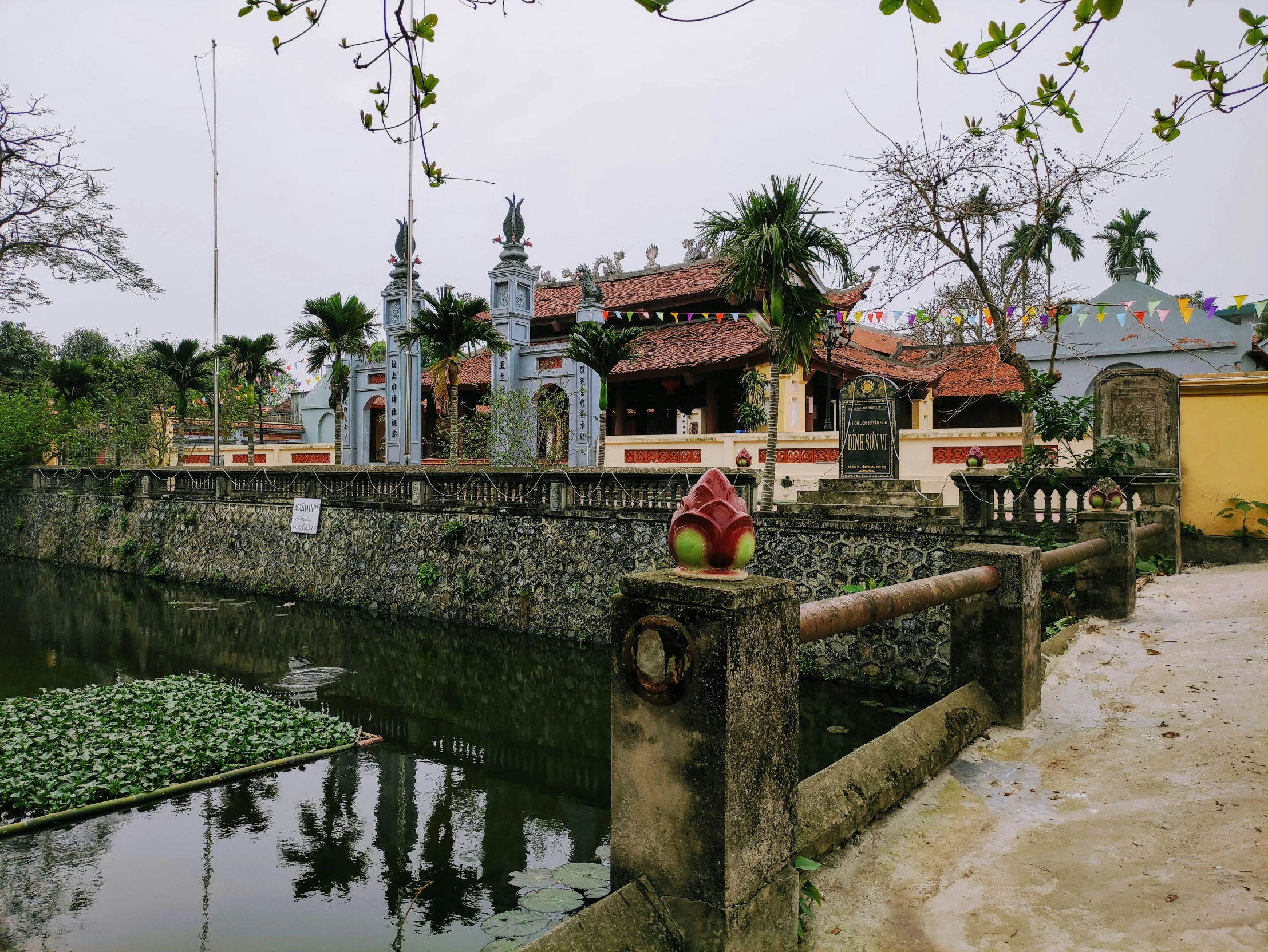 a red fire hydrant sitting in front of a water way