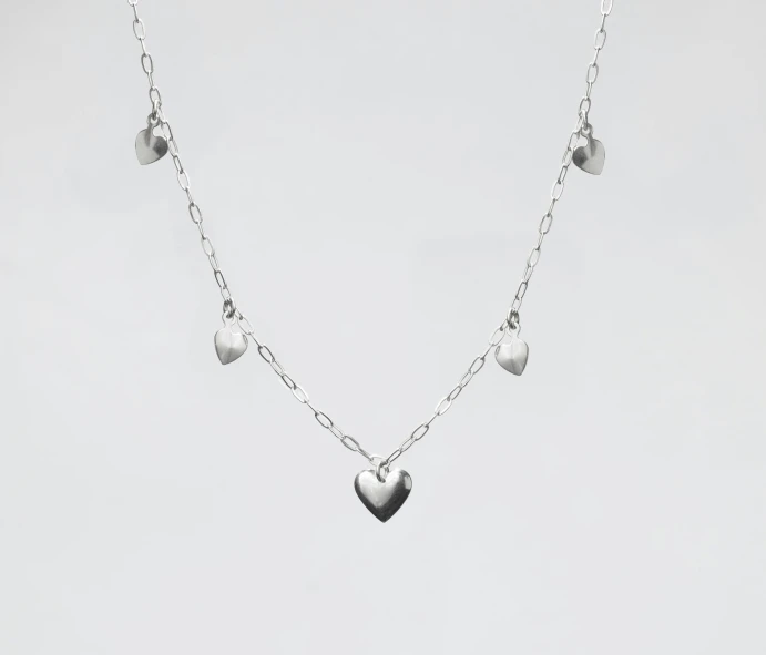 the small heart pendant is attached with silver chain