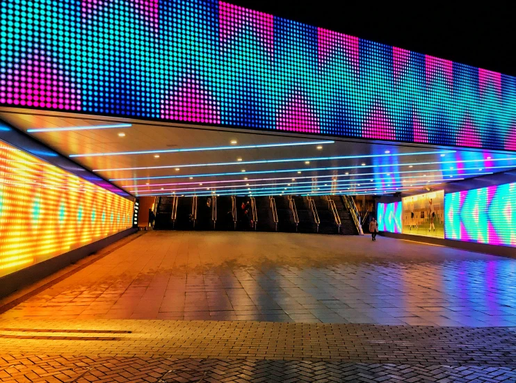 a brightly lit walkway with lights in the background