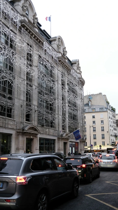 an old building covered in wire by traffic