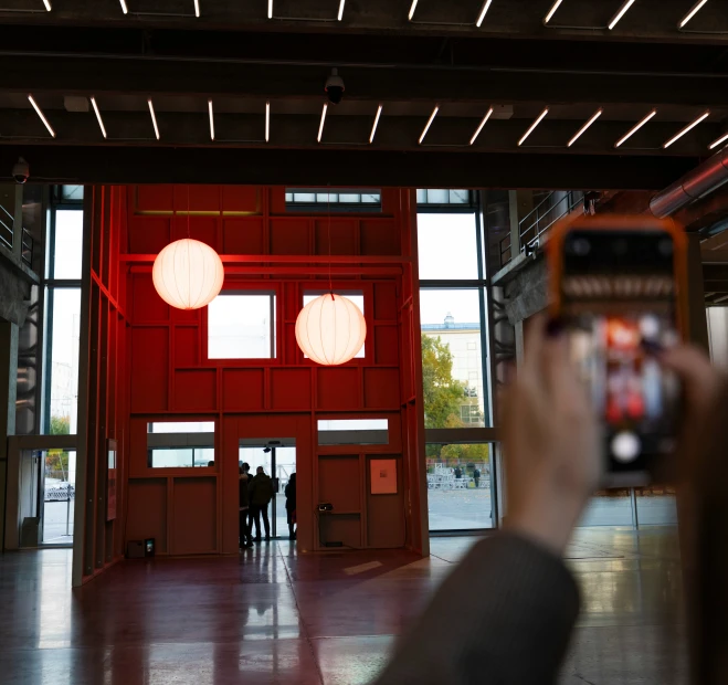 two people standing in the lobby next to a door