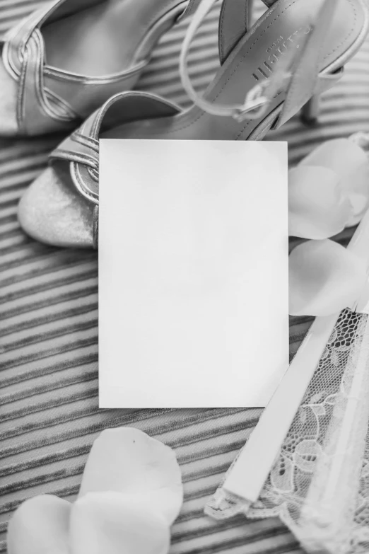 high heels and a card sit beside a pair of shoes