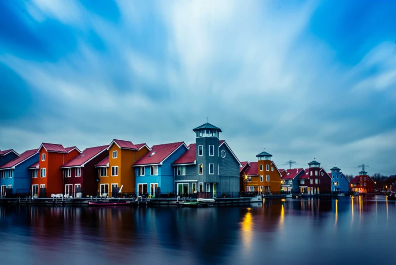 many houses on water in a town with red roofs