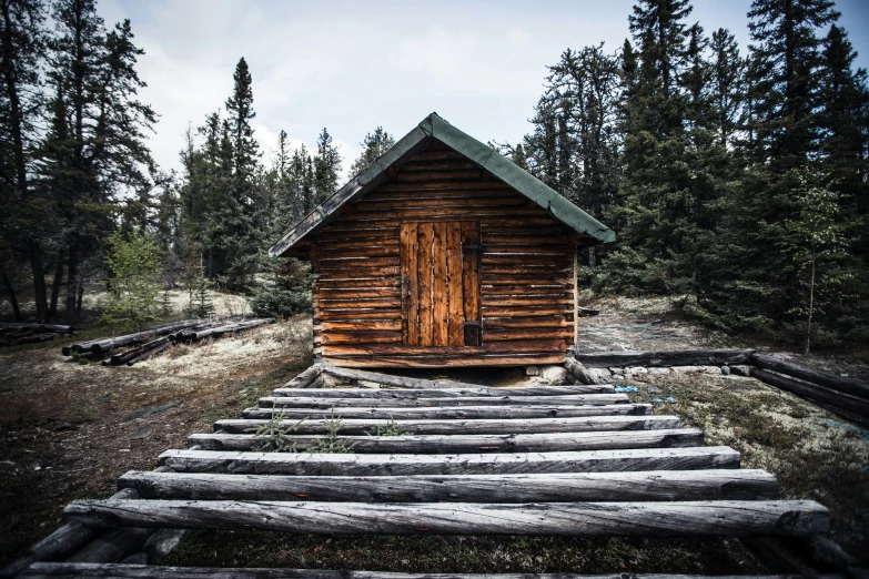 a log cabin with steps in front of it