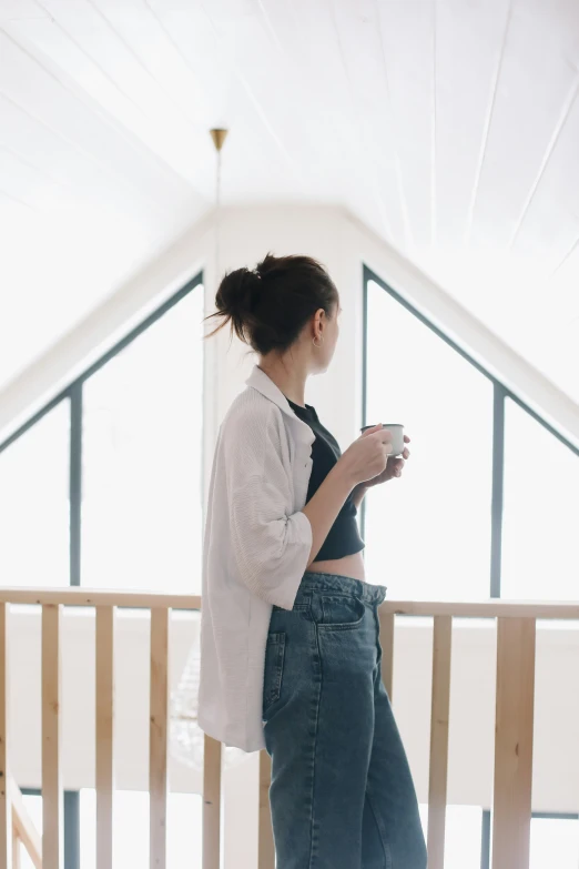 the woman is standing alone using her cellphone