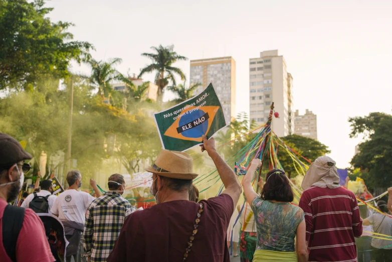 man in a crowd of people carrying flags