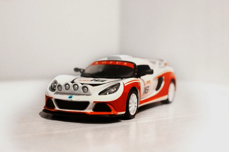 an orange and white car on a table