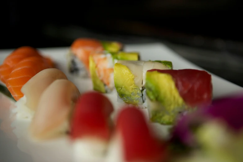 assortment of sushi with multiple kinds of vegetables