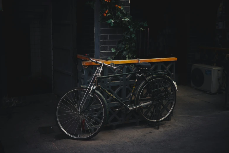 a close up of a bicycle near a brick wall