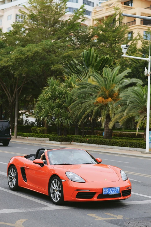 a bright orange sports car on the street