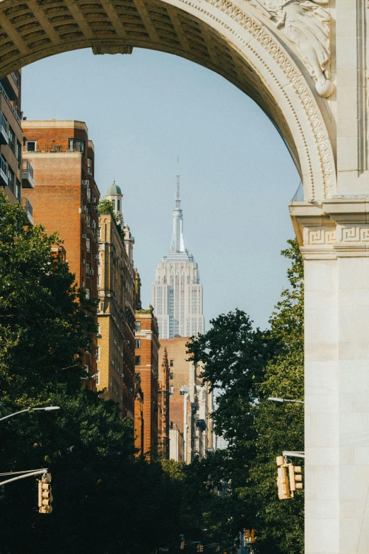 a street with a archway over it is lined with buildings