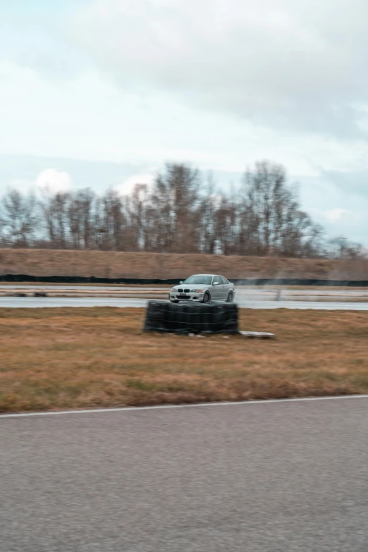 a truck driving through a wet field on top of a road