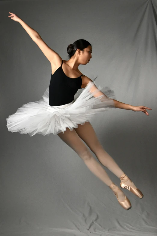 a ballerina is posing on the floor