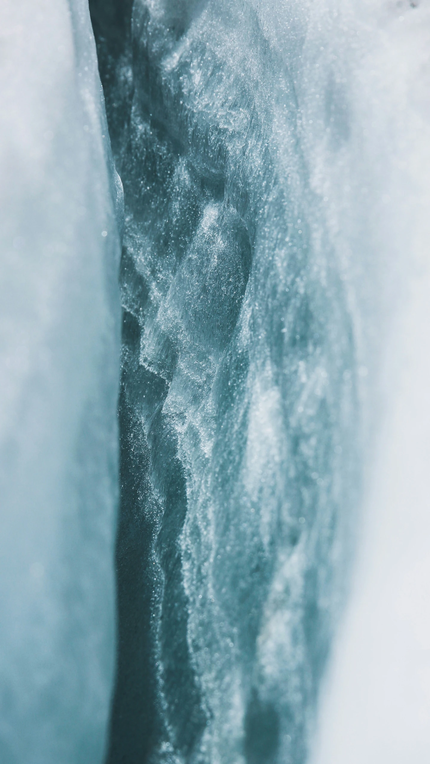 an icy icey river with water running from the bottom