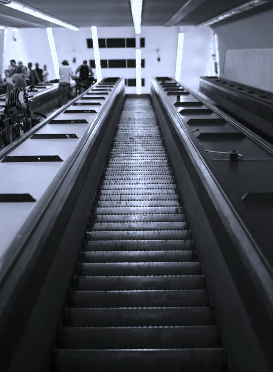 an escalator leads down an empty walkway