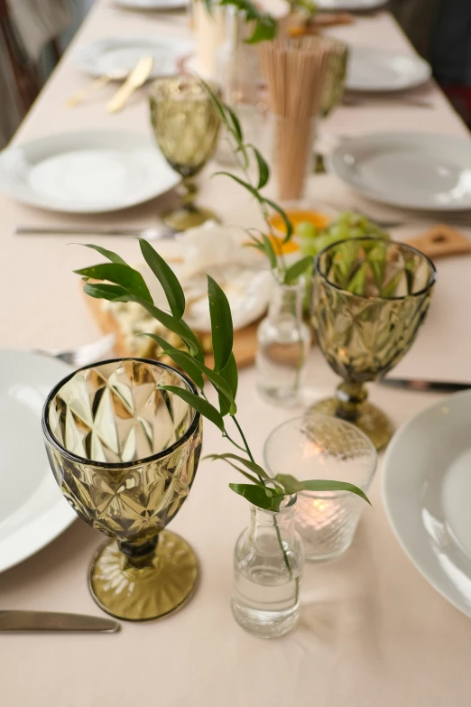 a table set with flowers and empty vases