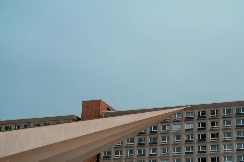 an airplane is flying over a building with a clock on it