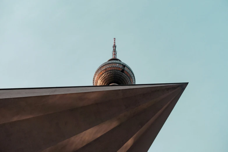 a large spire with the top of it up in front of a blue sky