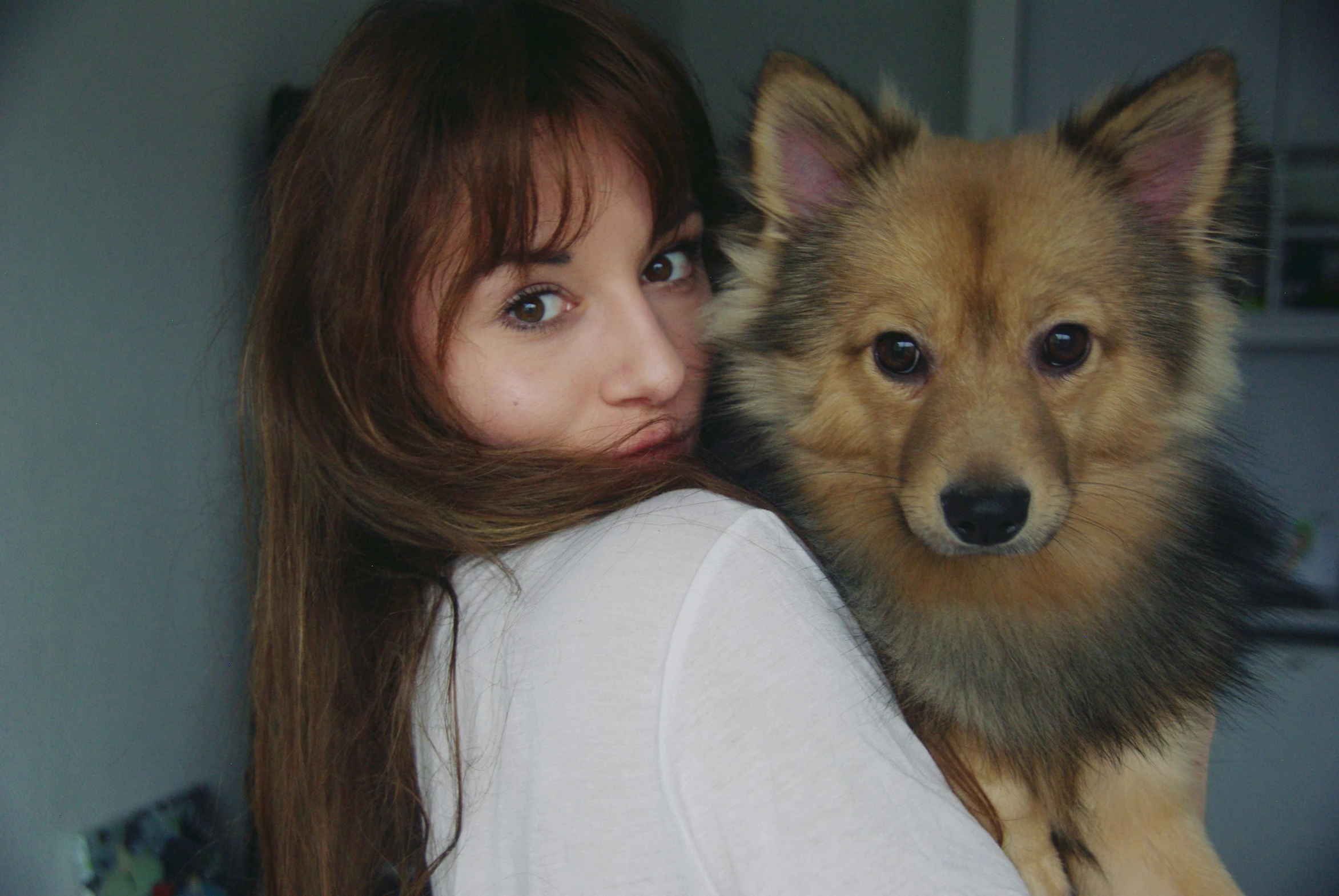 a girl and a dog posing for the camera