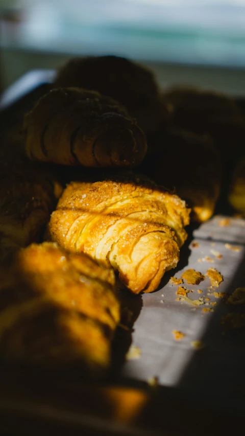 there are pastry rolls that are piled on the counter