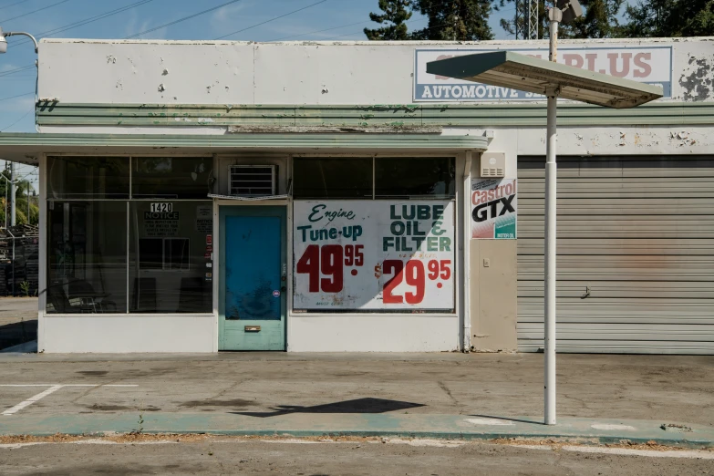 an empty building with a blue door and sign