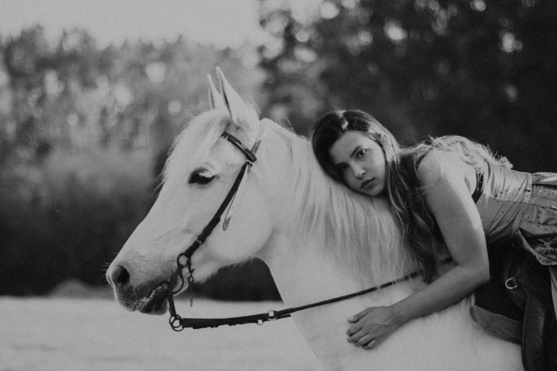 woman with long hair sitting on top of horse