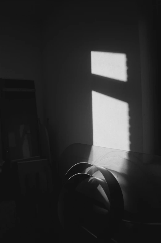 a room has a table and a light coming through the windows