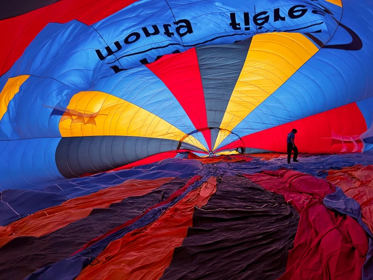 people are flying a large colorful  air balloon