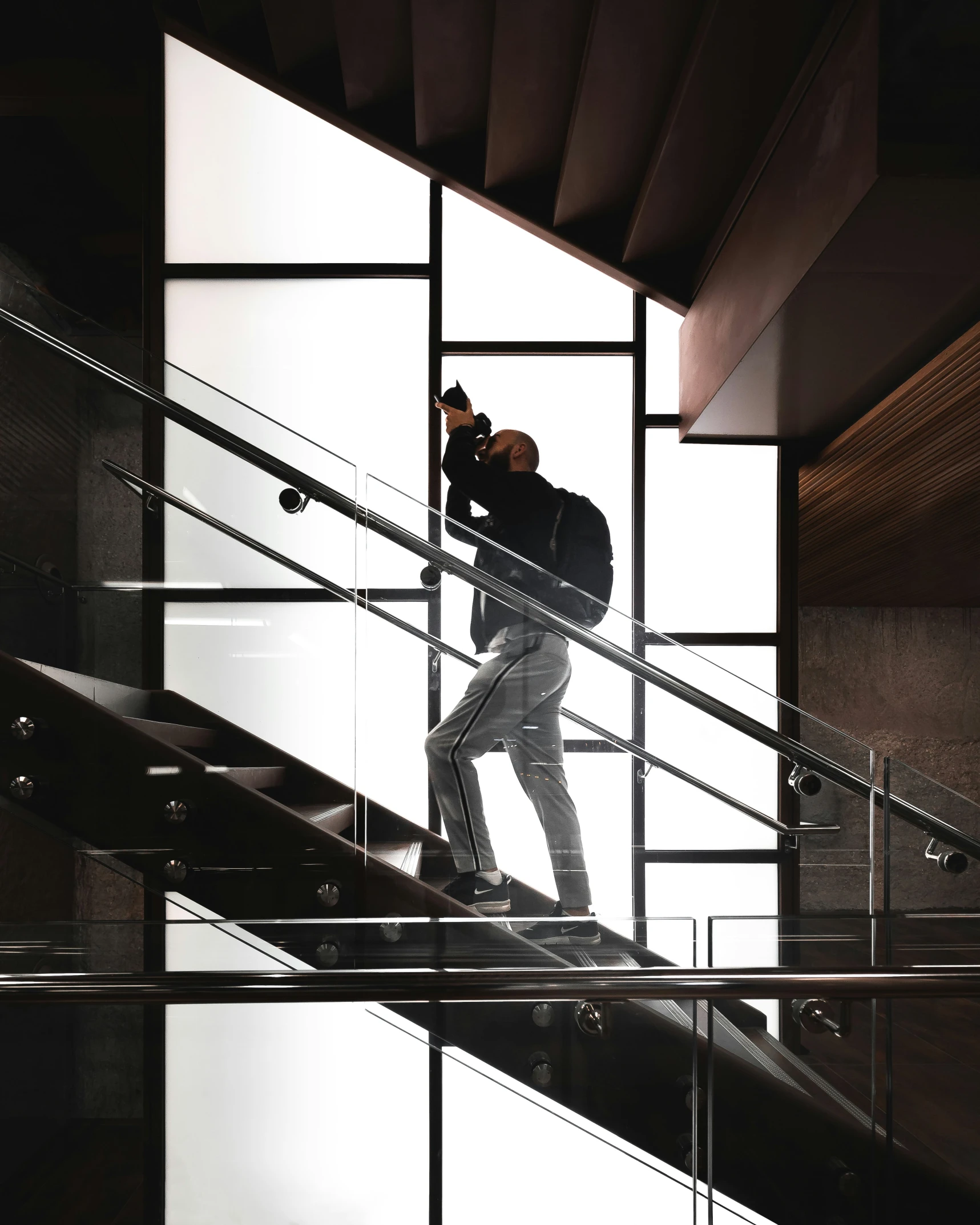 there is a man climbing the stairs in a building