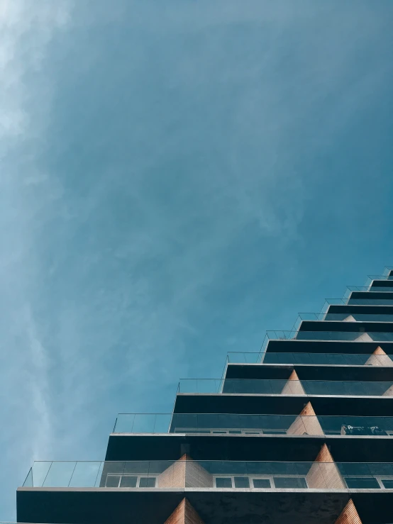 a pograph of a clock tower at the top of a building