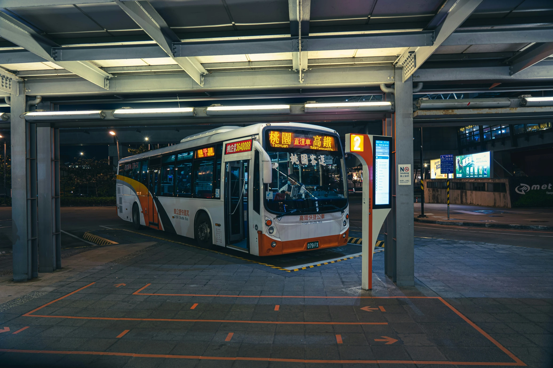 the bus has stopped at the station near the street