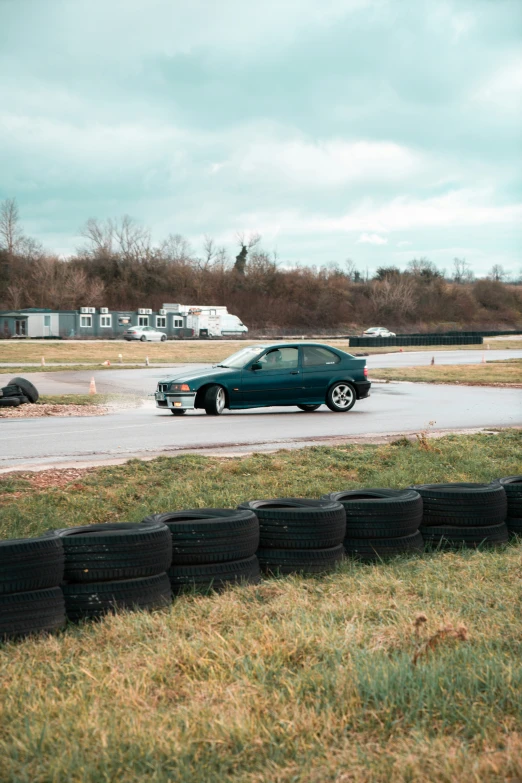 cars are parked on a grassy lot on a cloudy day