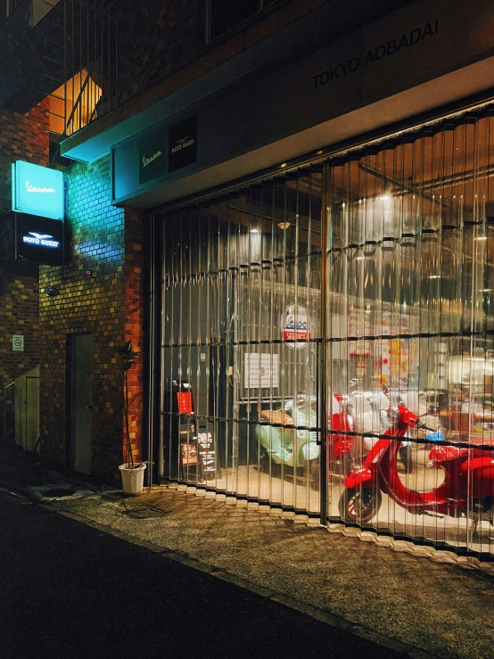 the view of a building with a motorcycle through a window