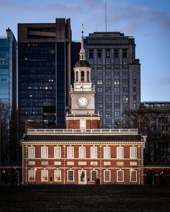 a brick building with a clock tower at dusk