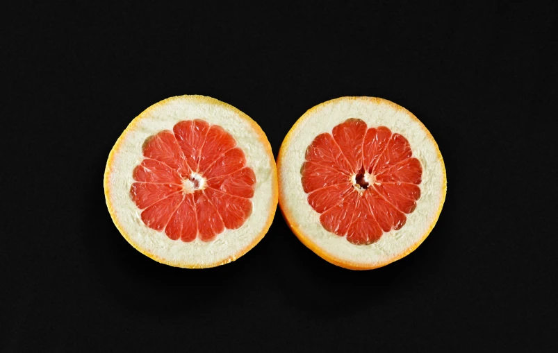 a fruit filled with a black background containing a  orange