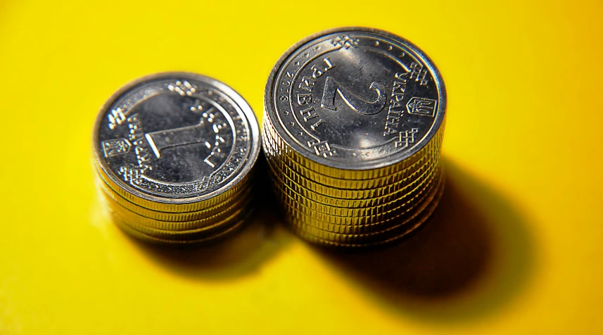 a pile of coins sitting on top of a yellow surface