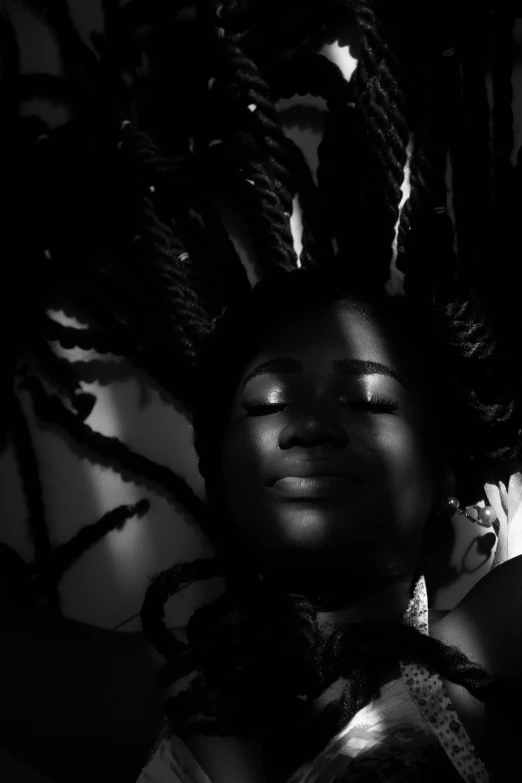 a woman with lots of dreadlocks in black and white