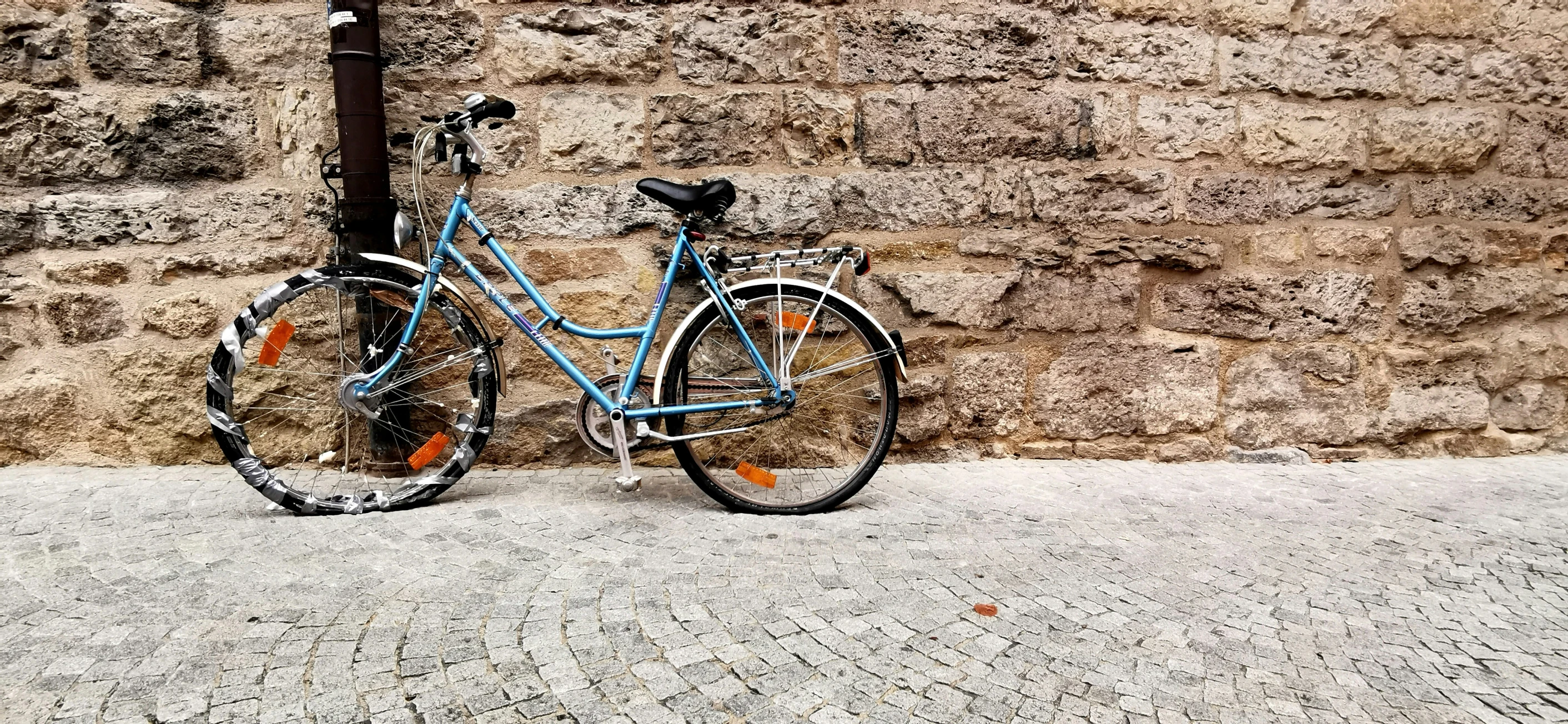 a bike leaned against a stone wall