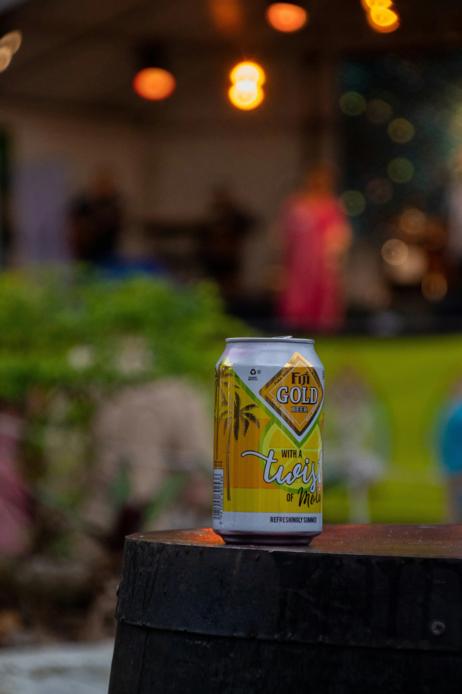 a can of beer sitting on top of a barrel