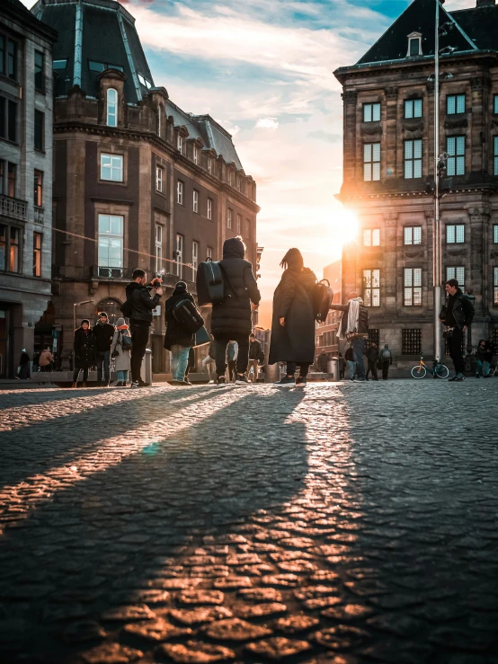 pedestrians walking on the street in front of a large building