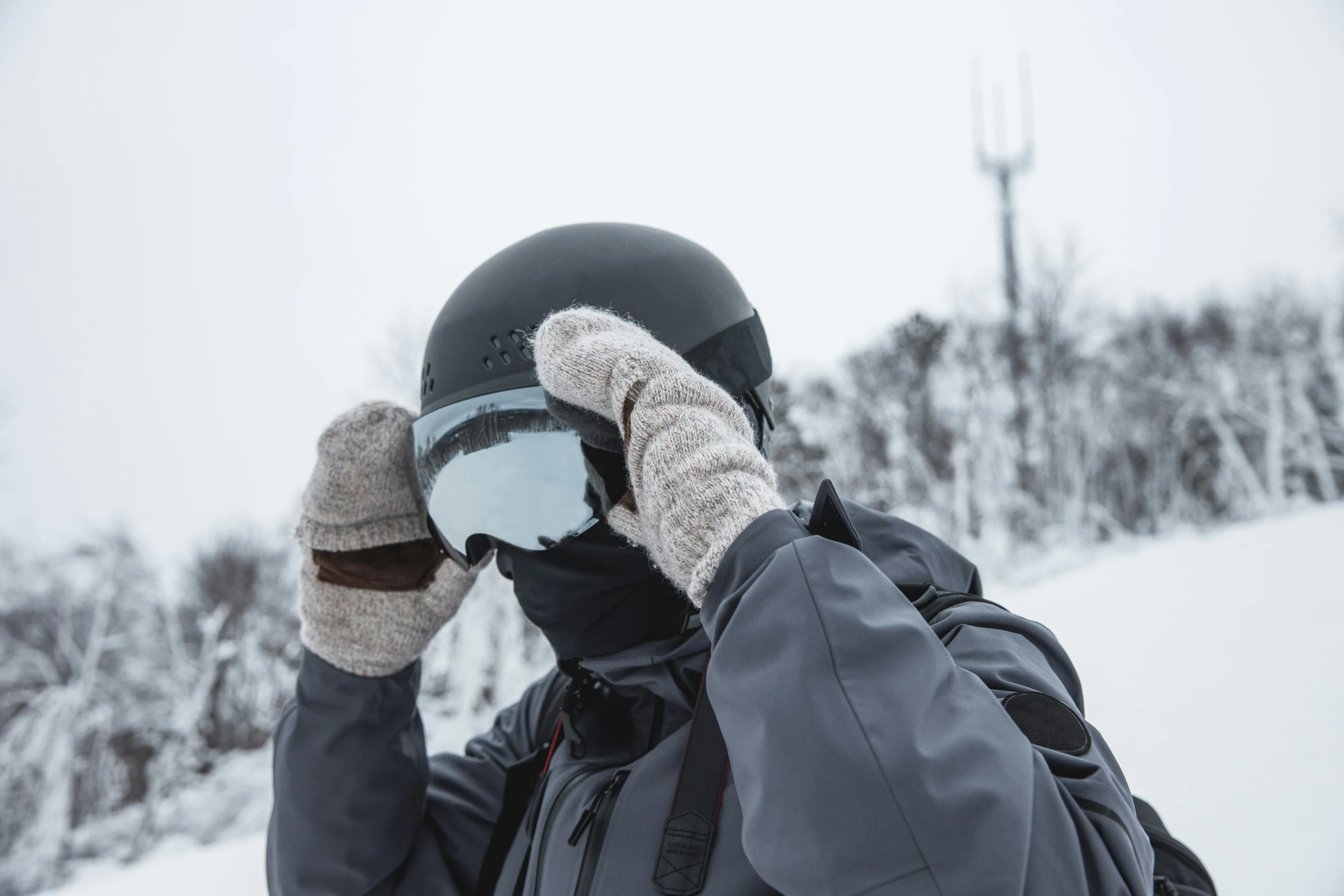 a person is holding onto a cup in the snow