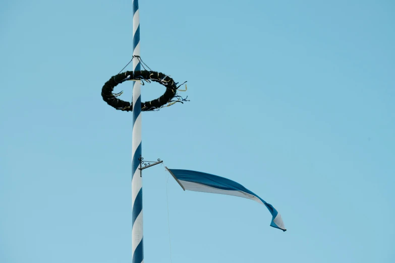 a pole with a wreath made of black tire on it