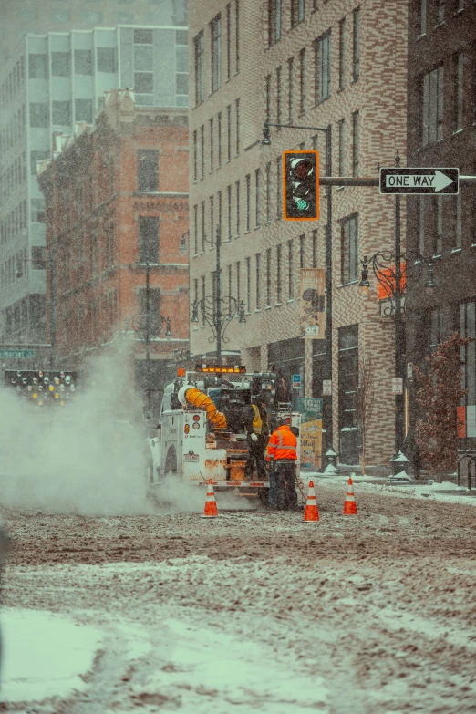 the city street is busy with snow and vehicles