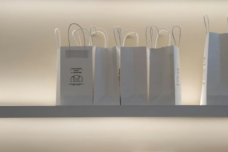 five small shopping bags on top of a shelf
