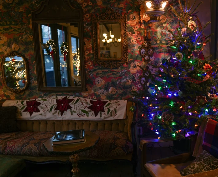 a decorated christmas tree sits in the corner of a room