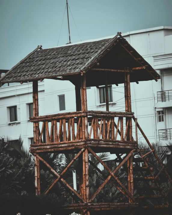 a tall building that has a wooden balcony and steps leading to it