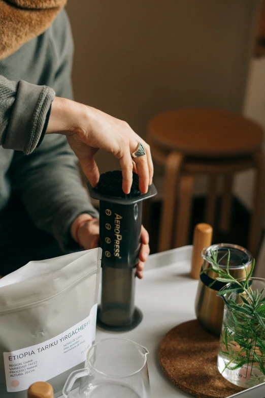 the person is holding the top half of the coffee cup